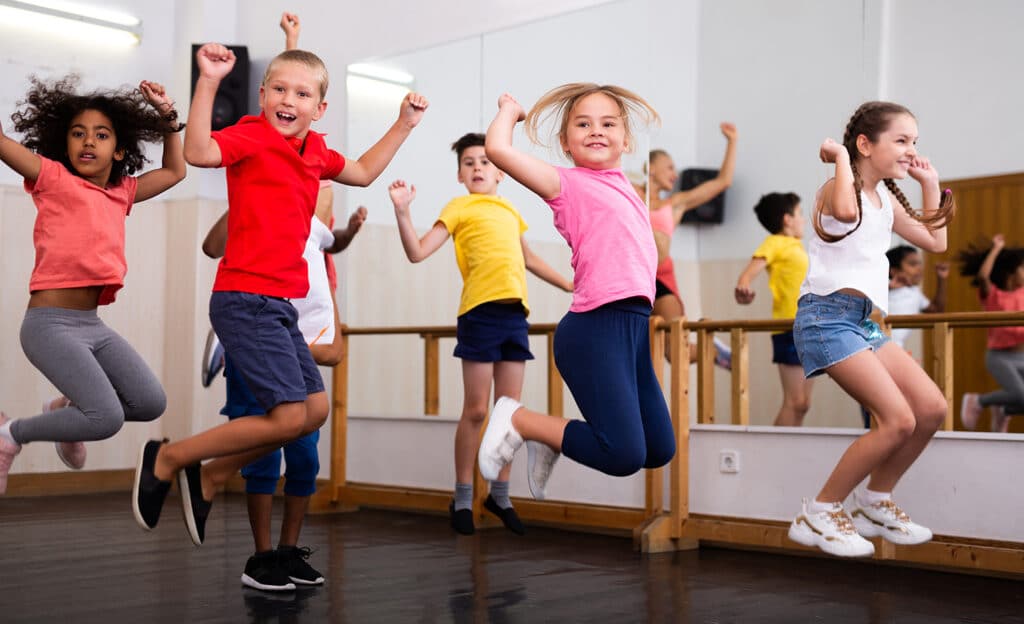 room full of kids jumping in a dance studio