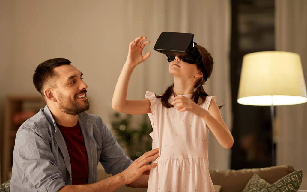 little girl and father playing with virtual reality