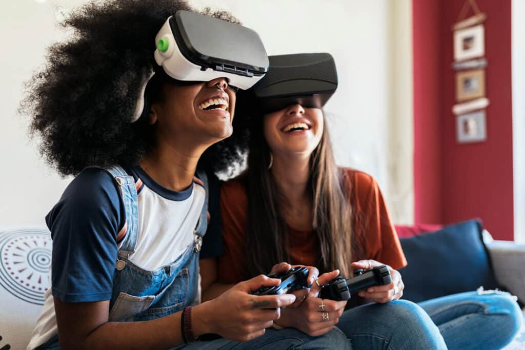 two girls smiling with virtual reality headsets