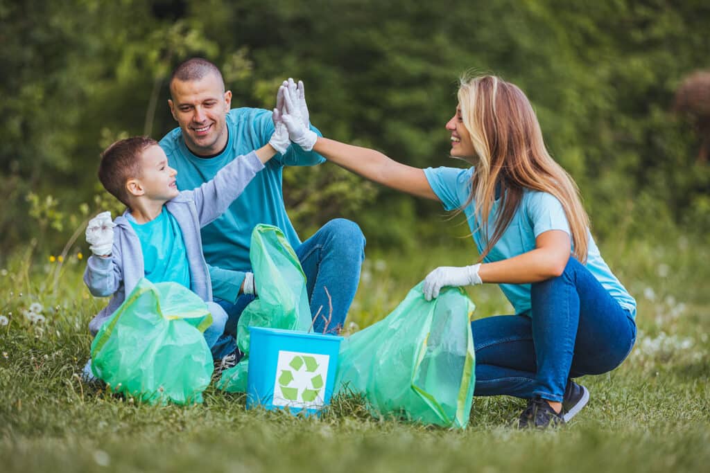 family high five as they sort recycling