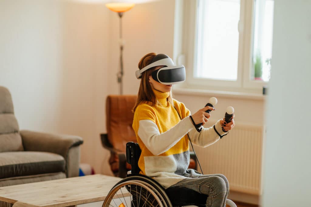 girl in wheelchair playing with virtual reality headset